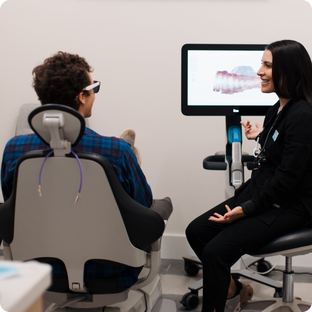 Doctor reviewing findings with a patient on screen