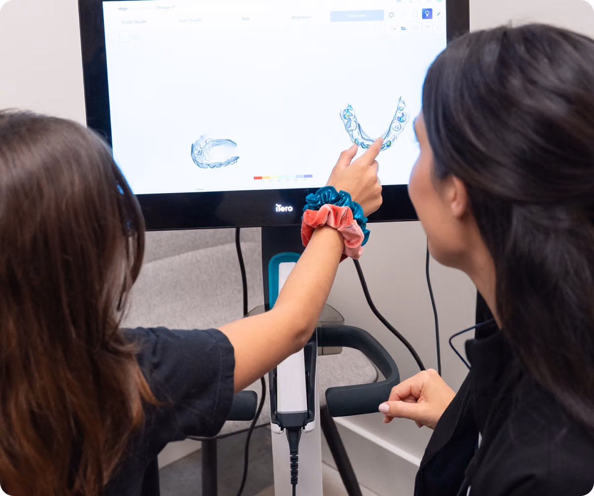 Doctor walking a patient through findings on a display