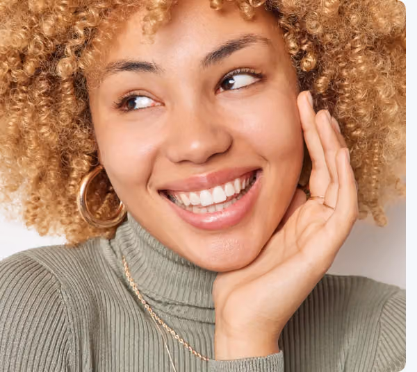 Smiling woman showing bright porcelain veneers.
