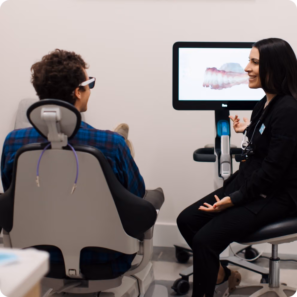 Doctor reviewing findings with a patient on screen