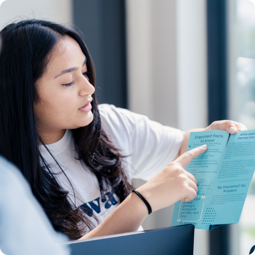 A doctor and team member speaking with a patient