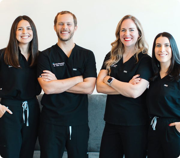 Four Airway Dentists providers standing together in black scrubs.