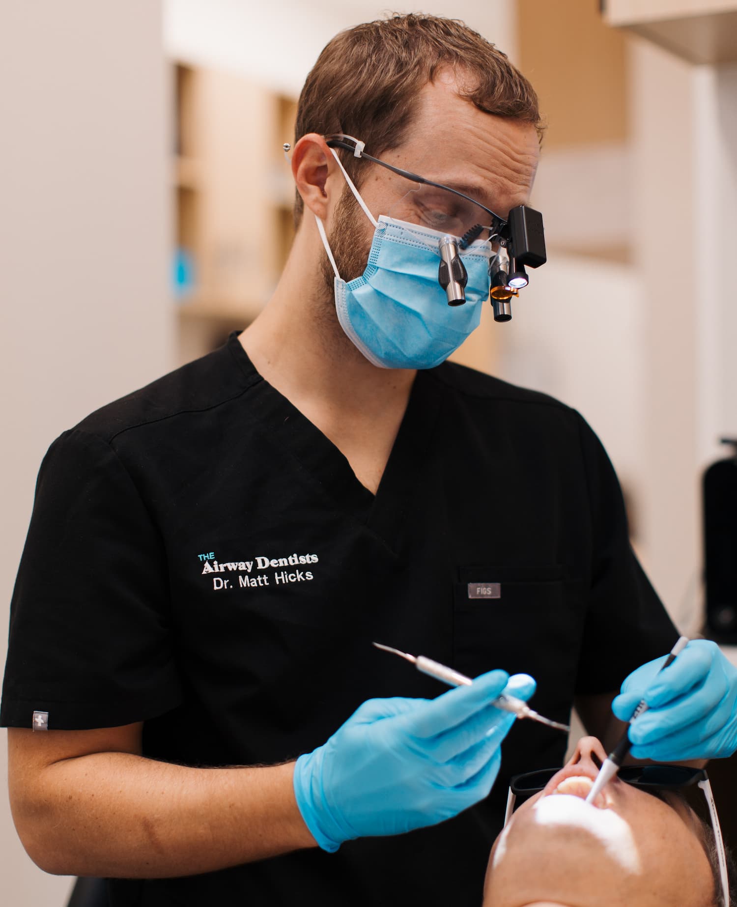 Dr. Matt Hicks performing a biologic dental procedure on a patient