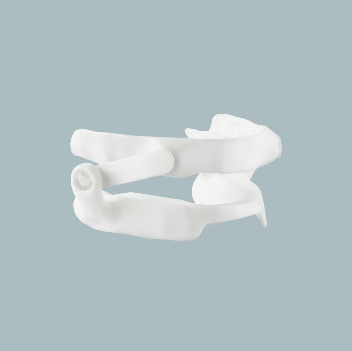 A white plastic dental mouthpiece with upper and lower trays, shown against a light grey background.