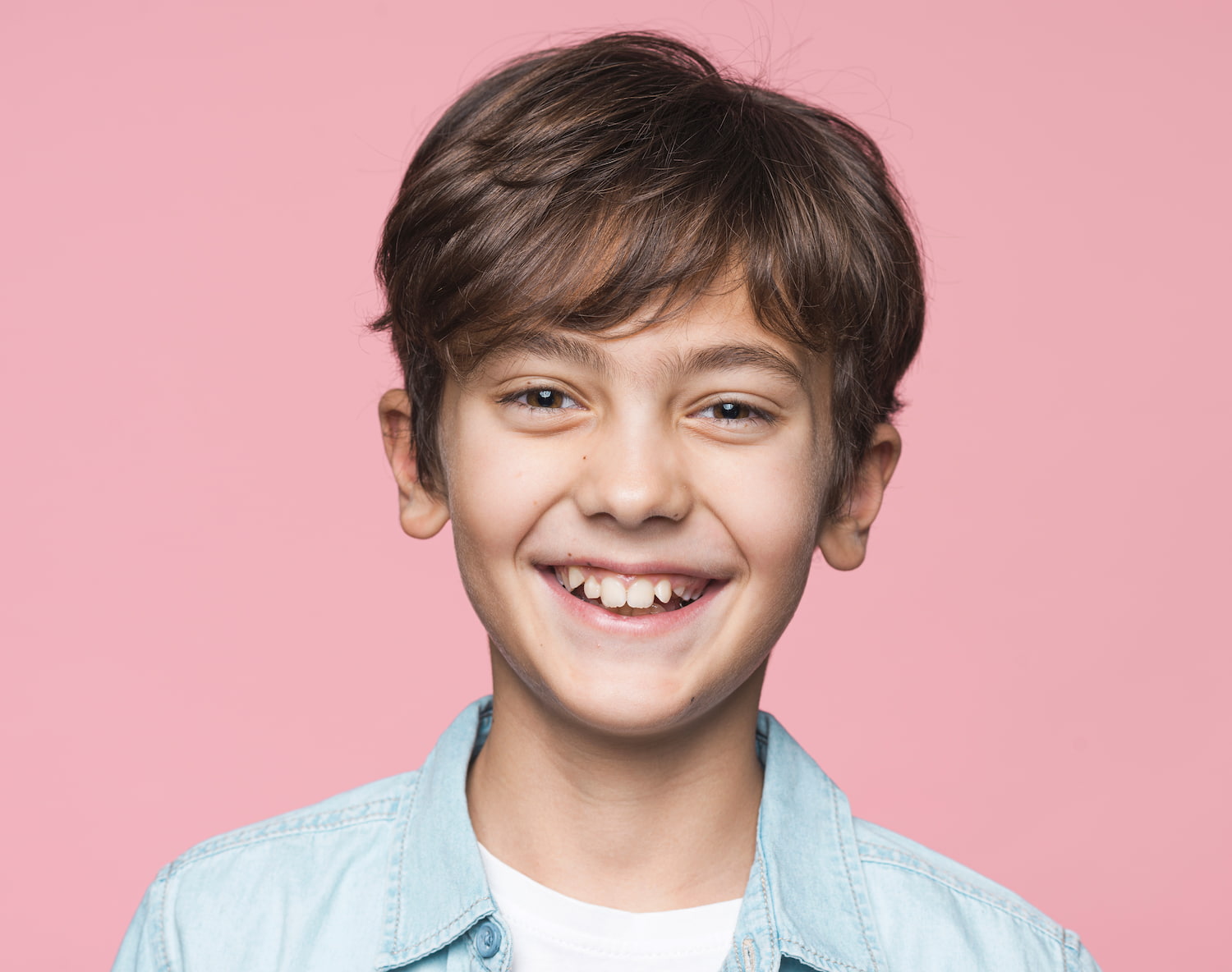 Smiling young boy after airway dentistry treatment for improved breathing and sleep